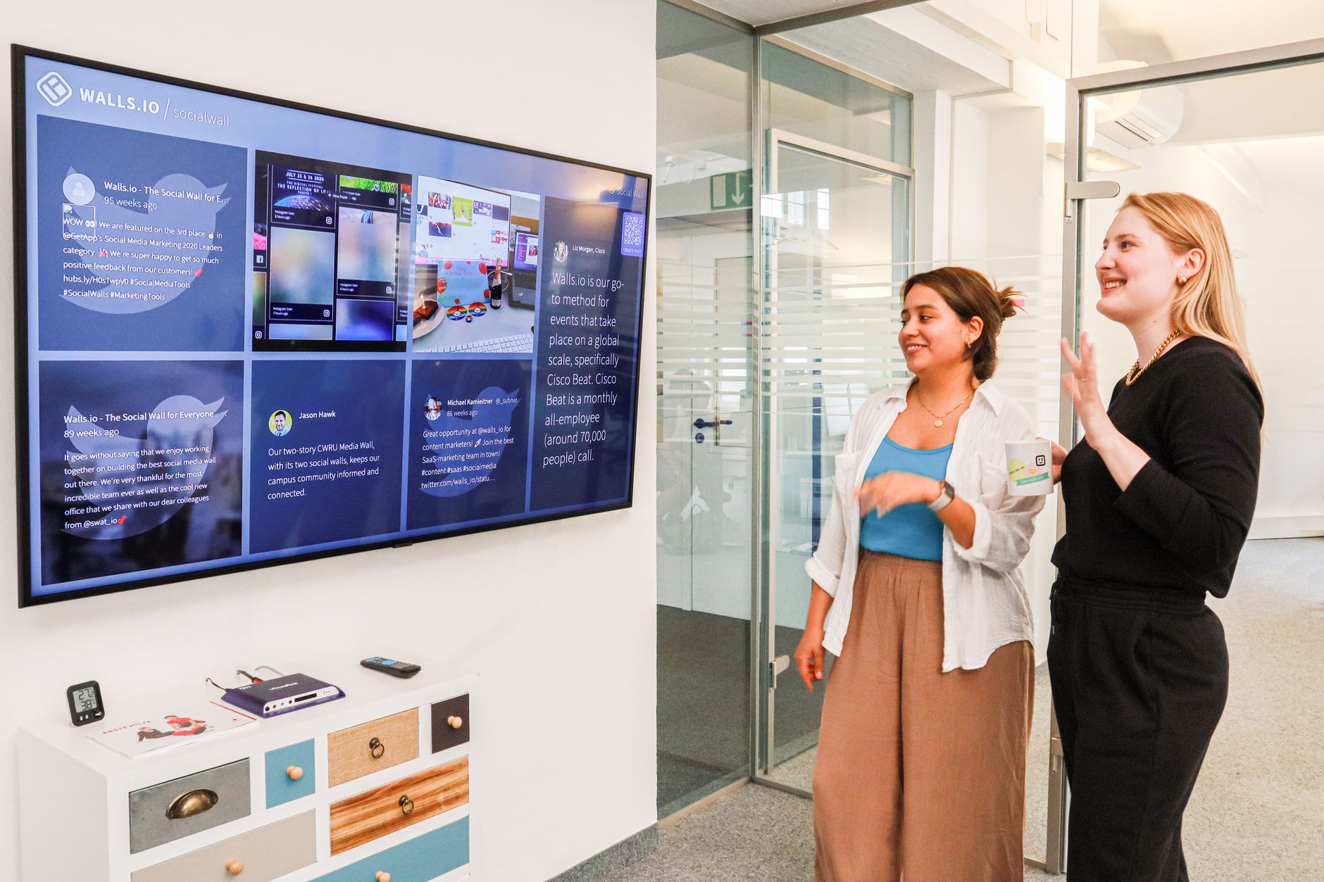Small marketing team reviewing content workflow on shared screens