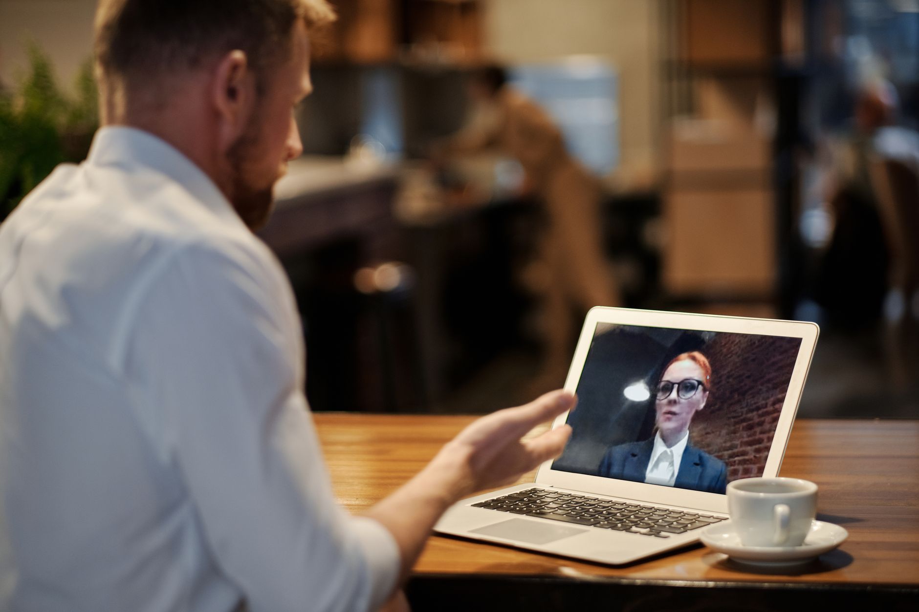 Person on a video call with multiple participants visible on a laptop screen