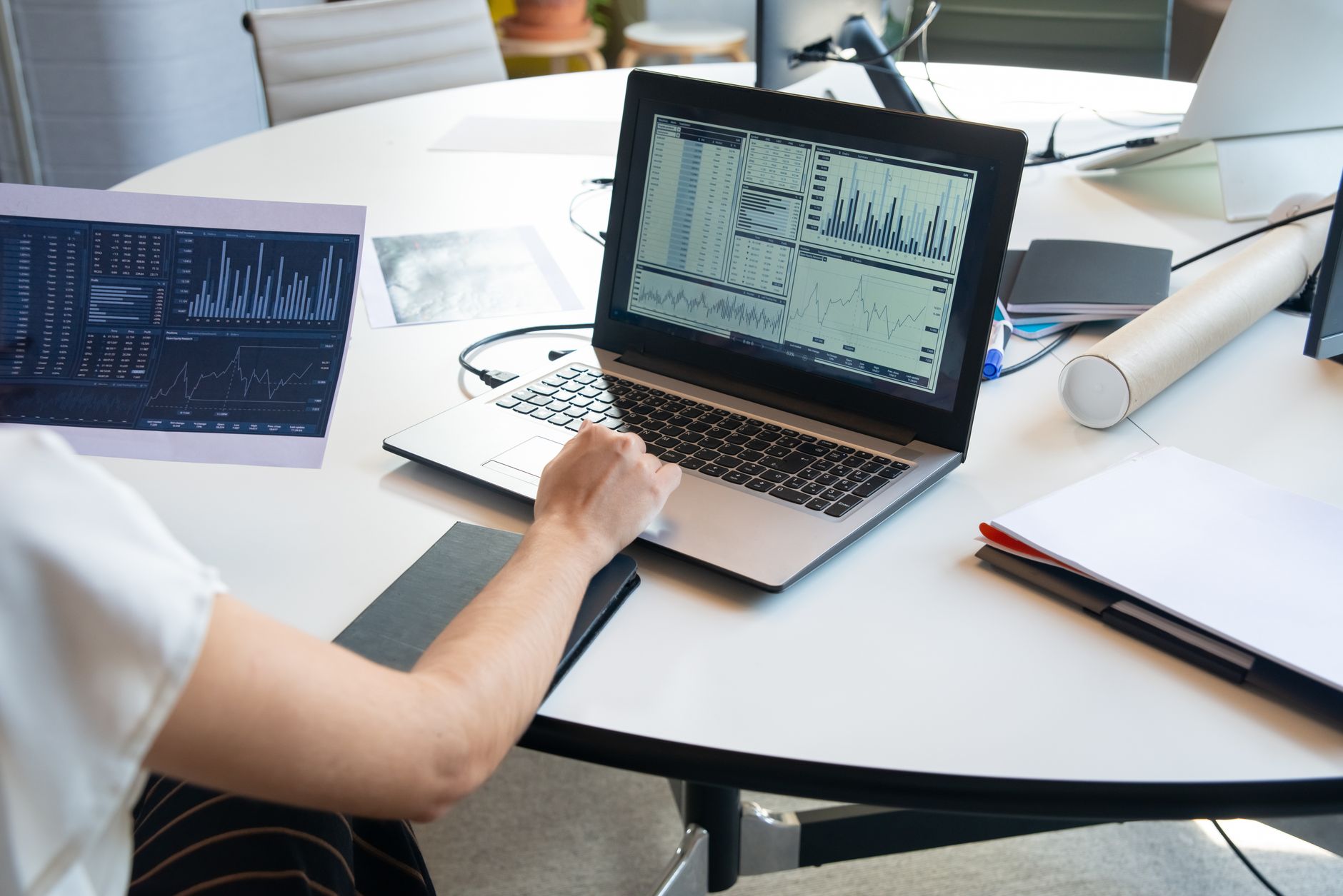 A professional reviewing data analysis charts on a computer screen