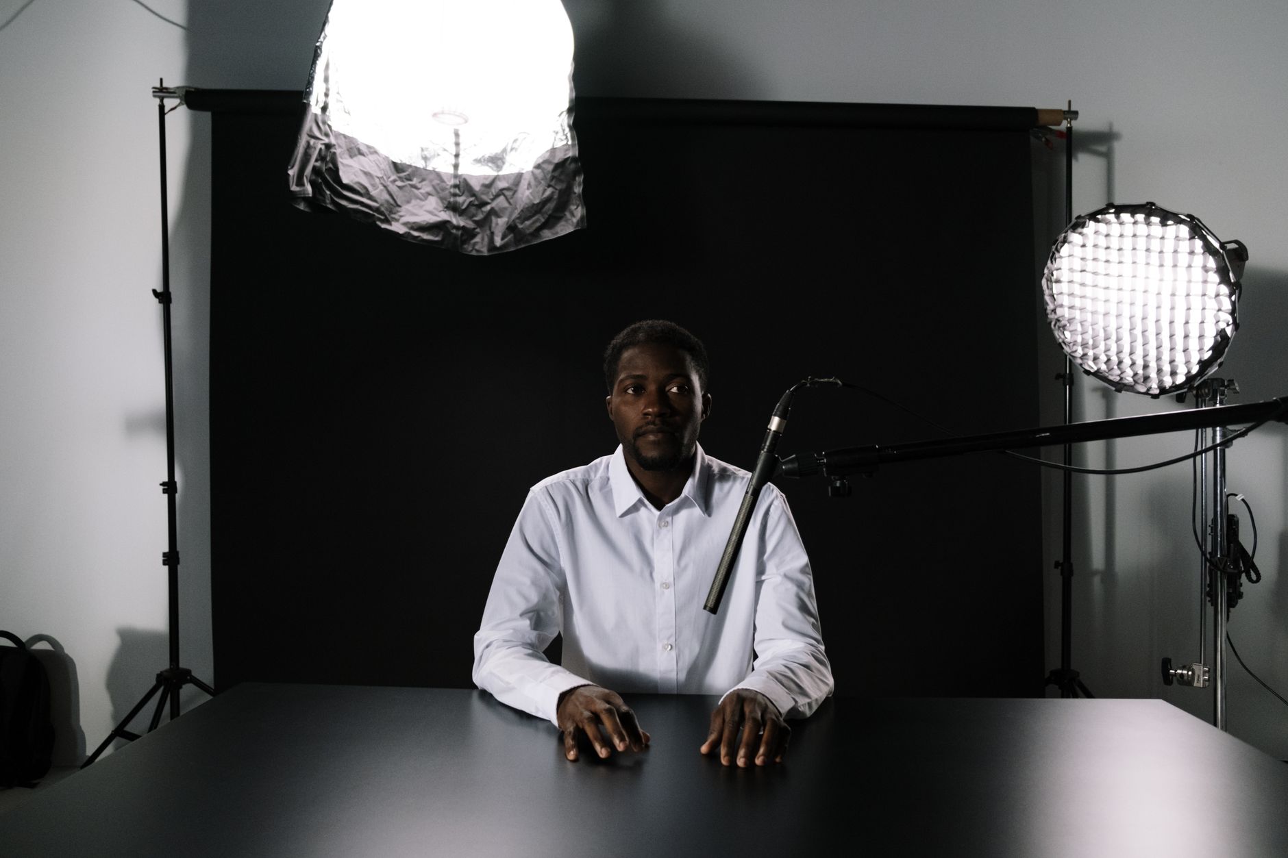 Individual recording a podcast alone in a minimalist home studio