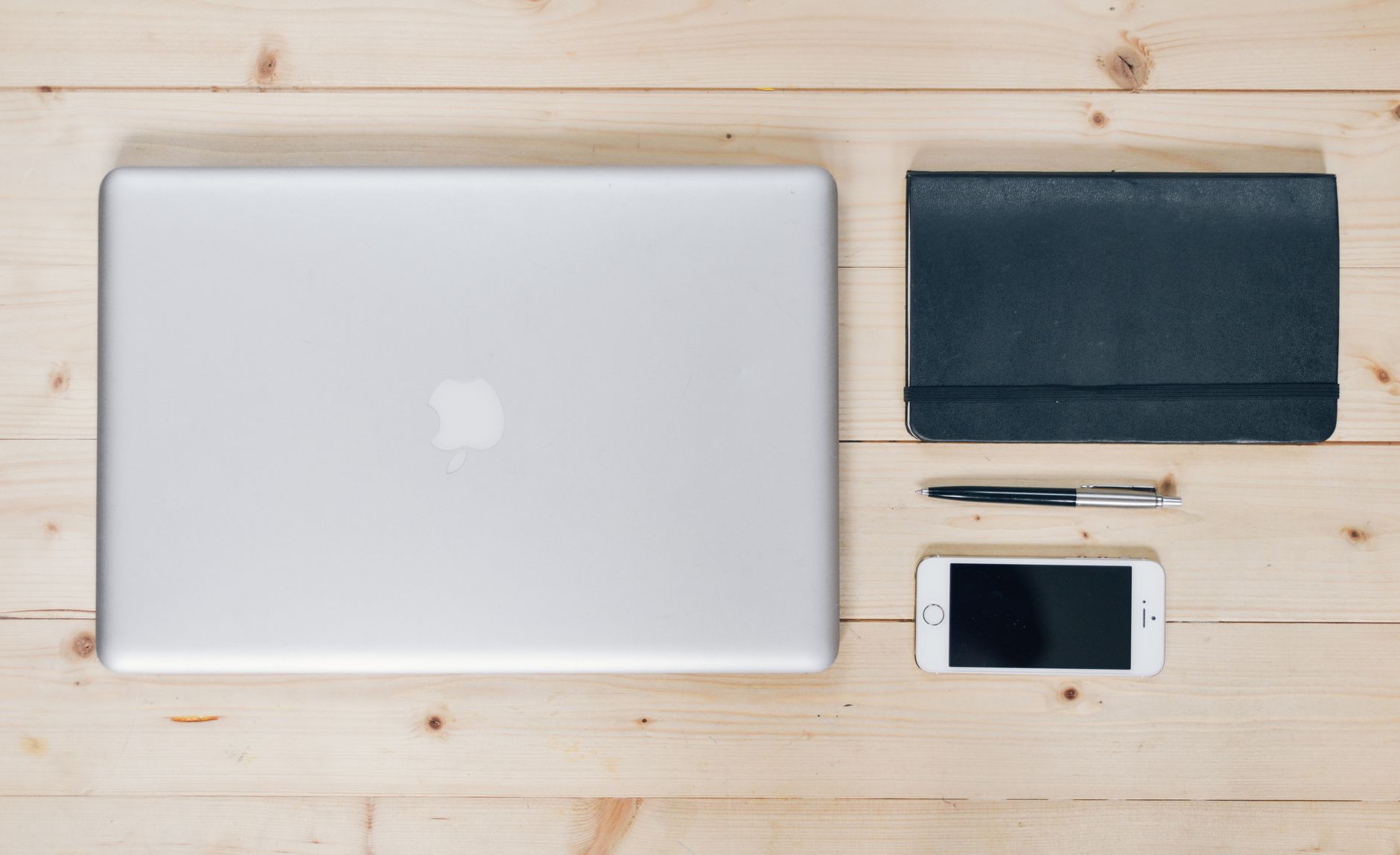 An organized desk workspace with a laptop open to a project management interface