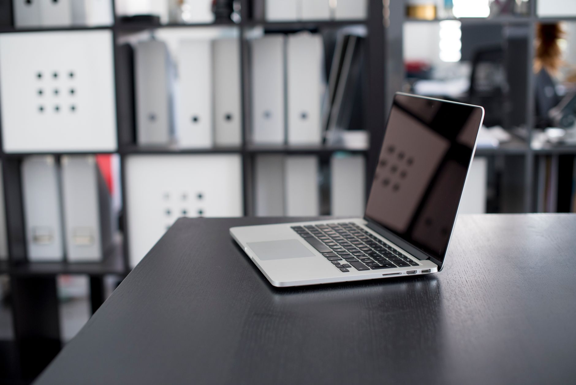 Marketing operations professional working at a desk with multiple screens open