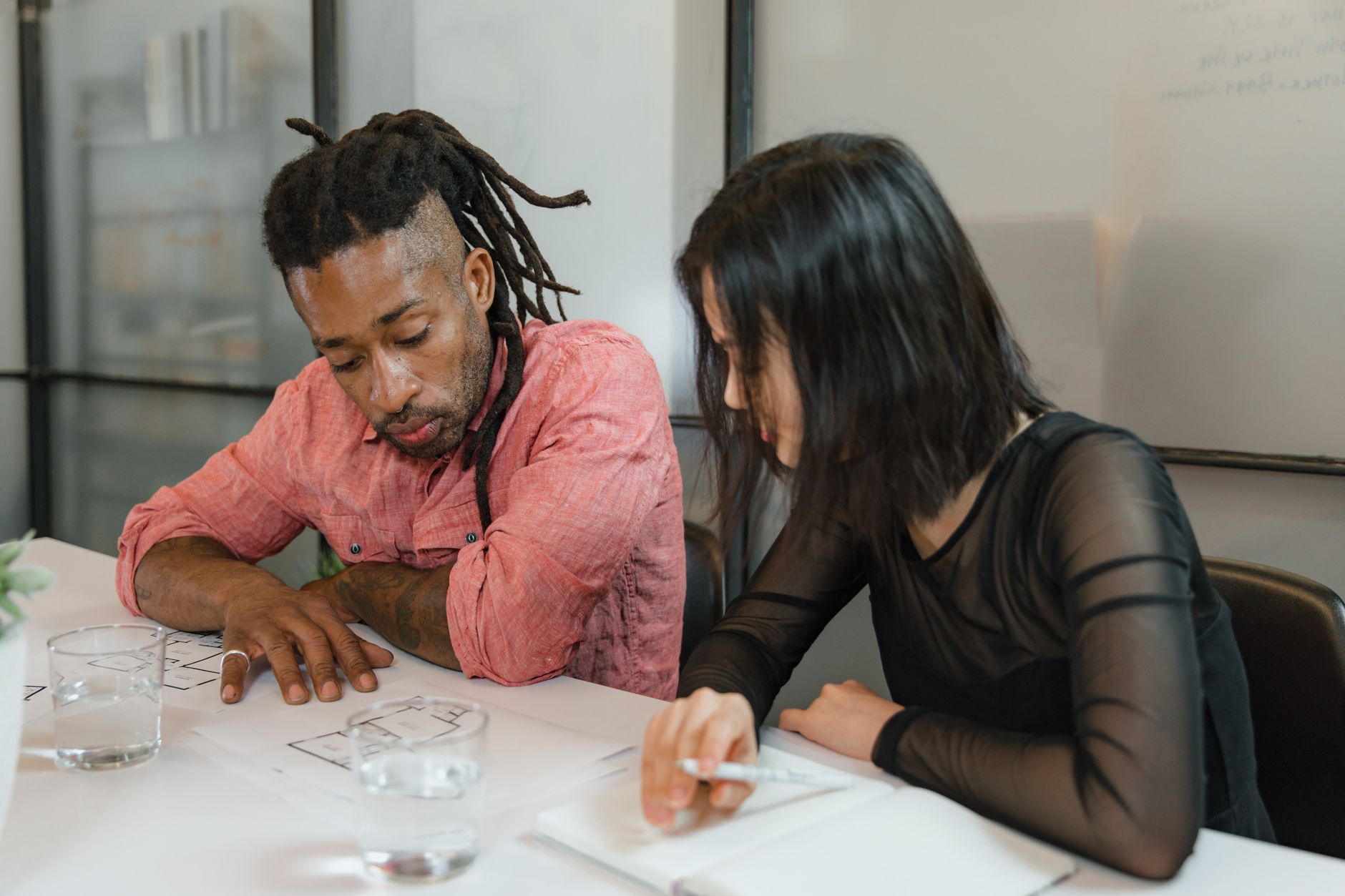 Small marketing team reviewing documents together in a modern office setting