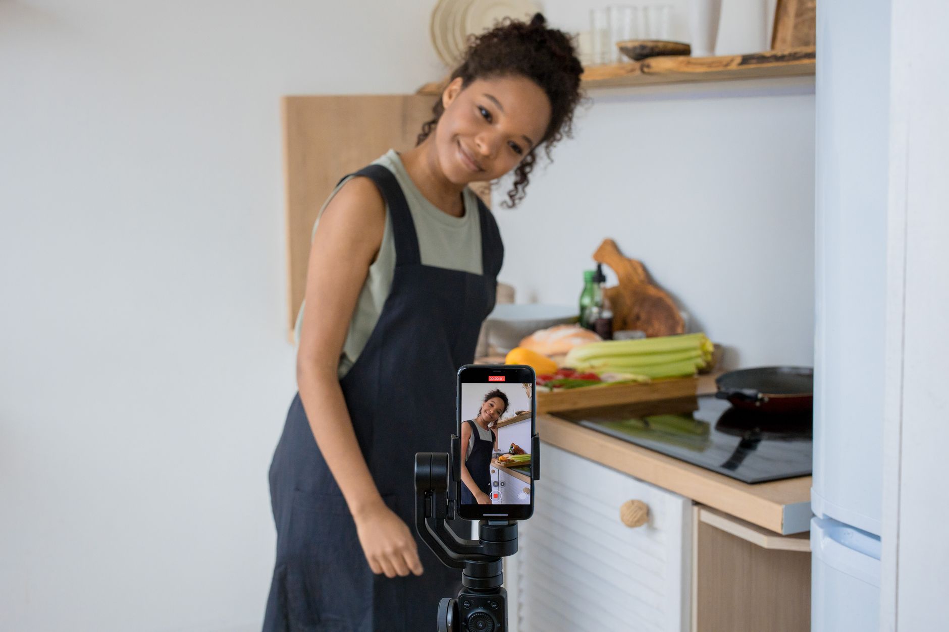 Solo content creator filming a short-form video in a home studio setup