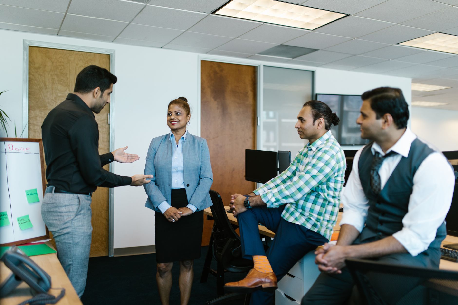 Enterprise marketing team gathered around a table discussing platform consolidation strategy