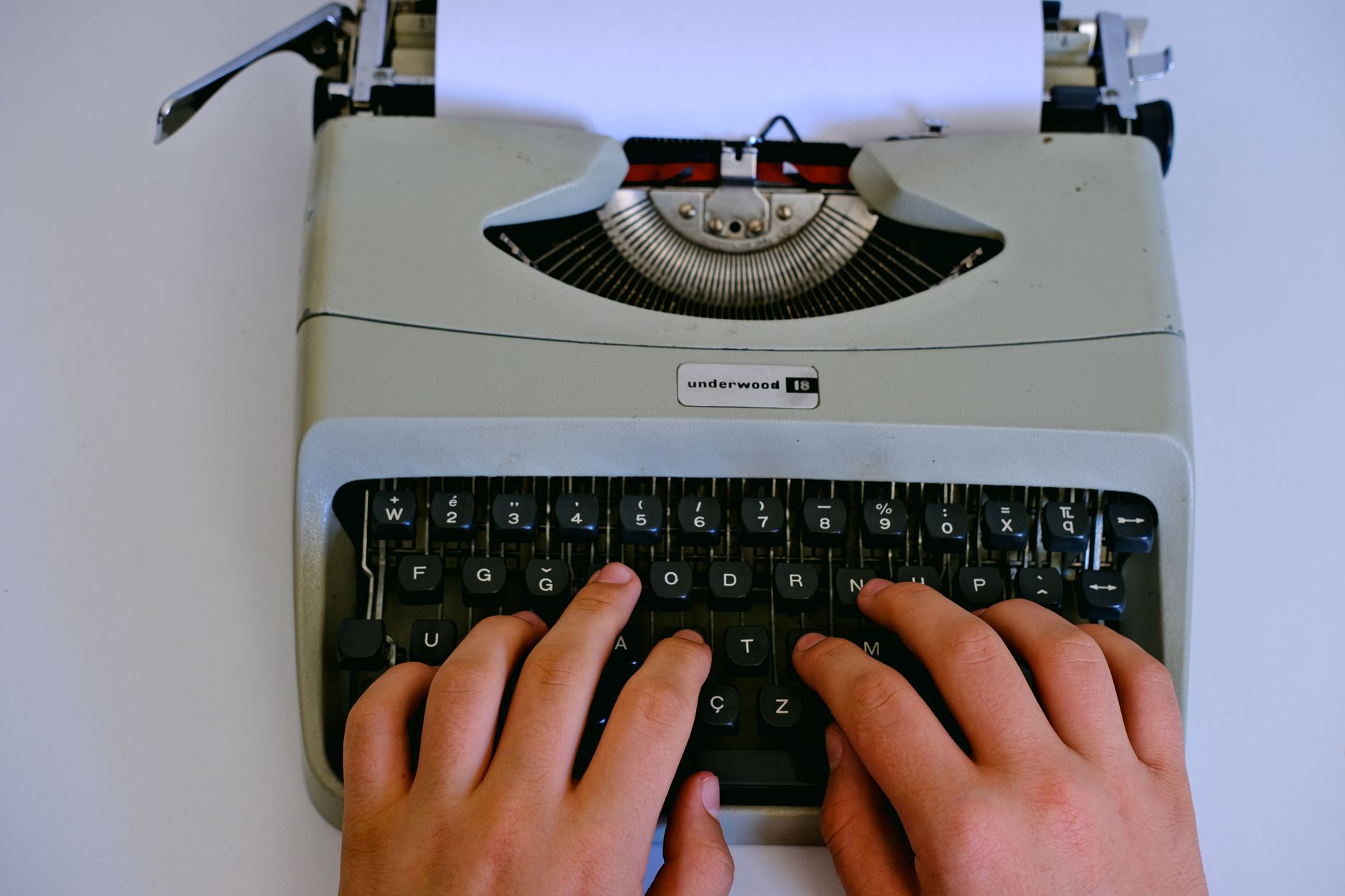 Professional typing on a keyboard while managing digital content workflow