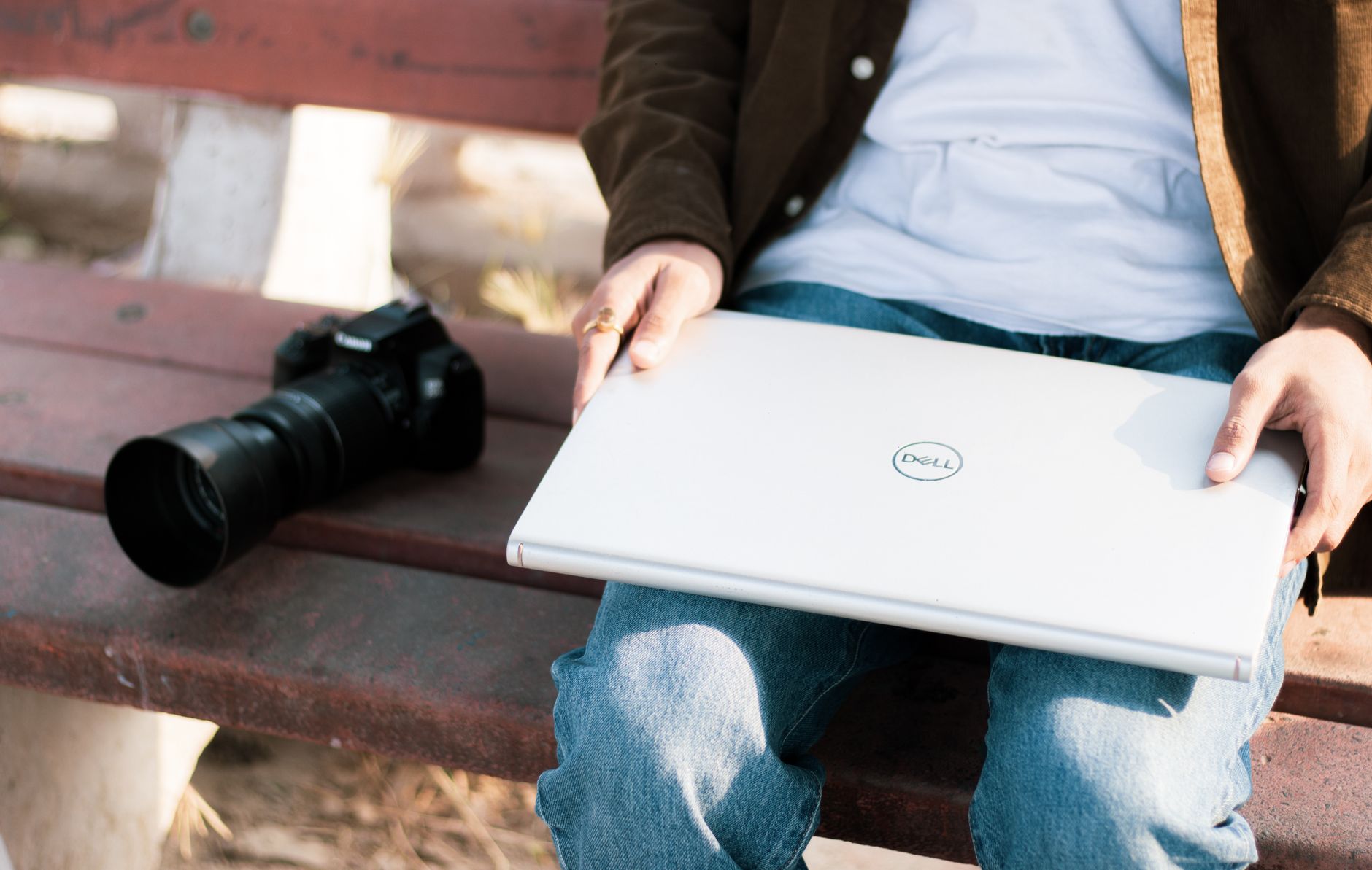 A content creator working on audio and video editing software on a laptop