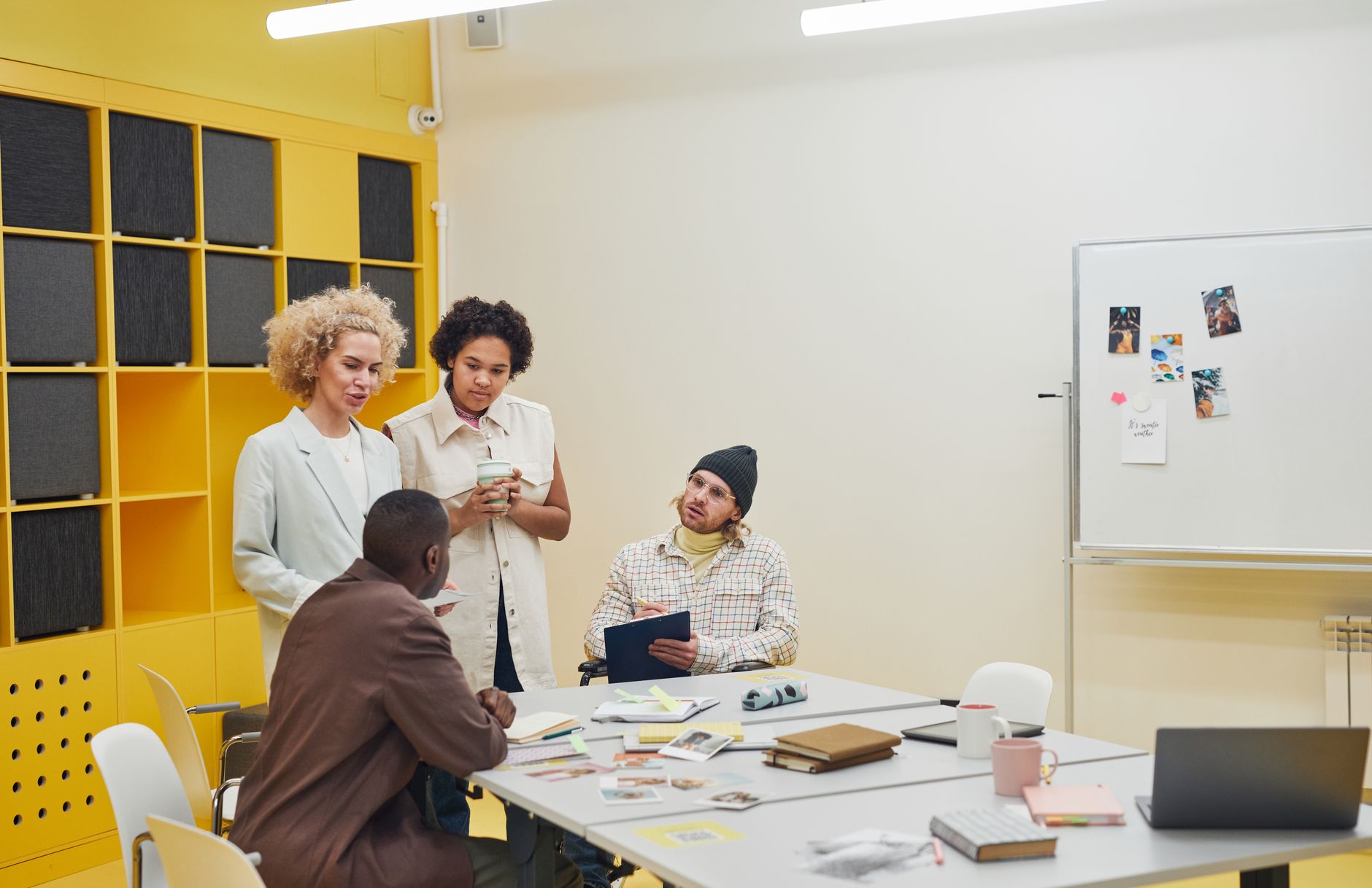 A small agency team reviewing reports and strategy documents around a conference table
