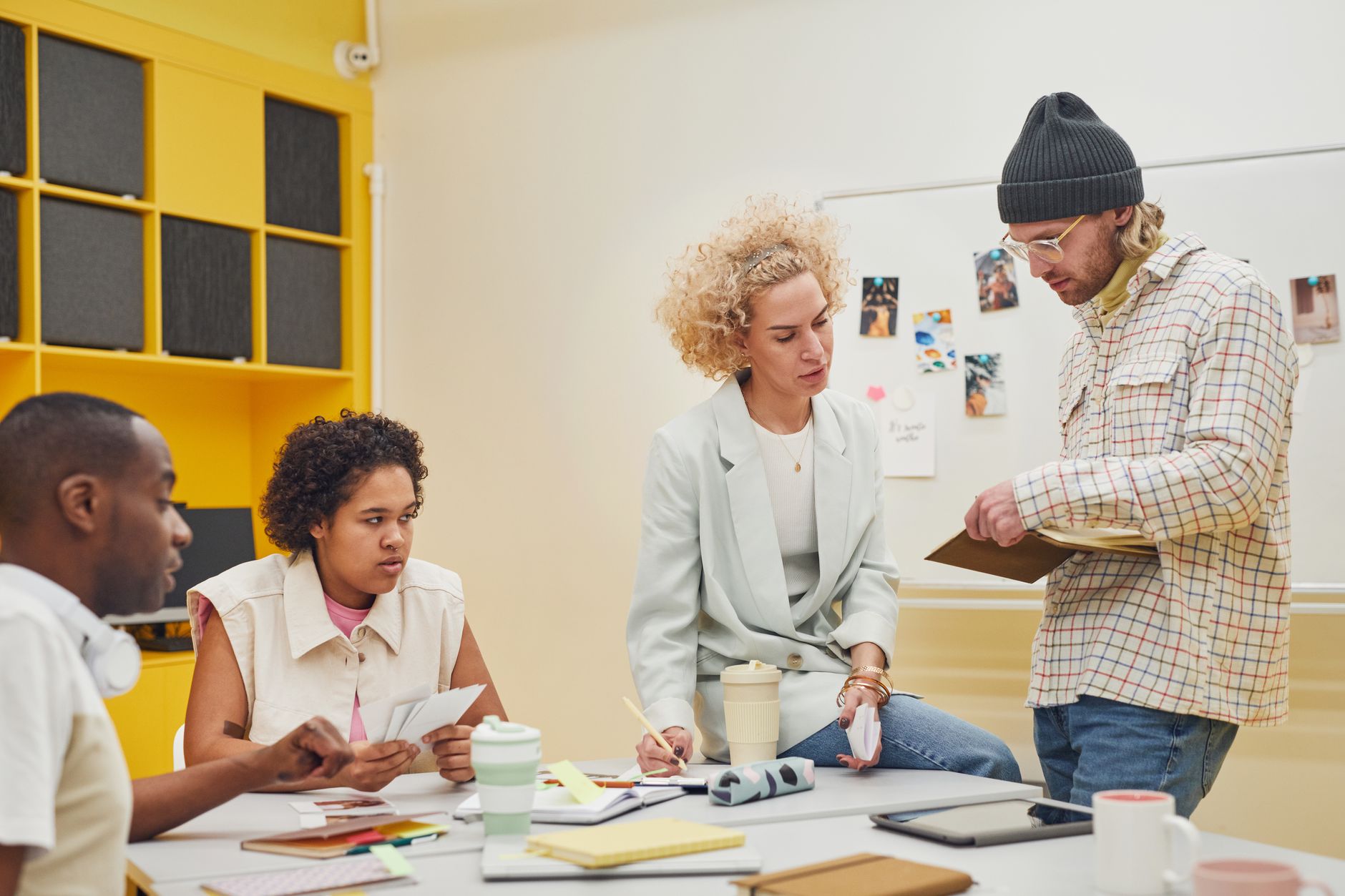 Creative professionals collaborating on campaign materials in a modern office