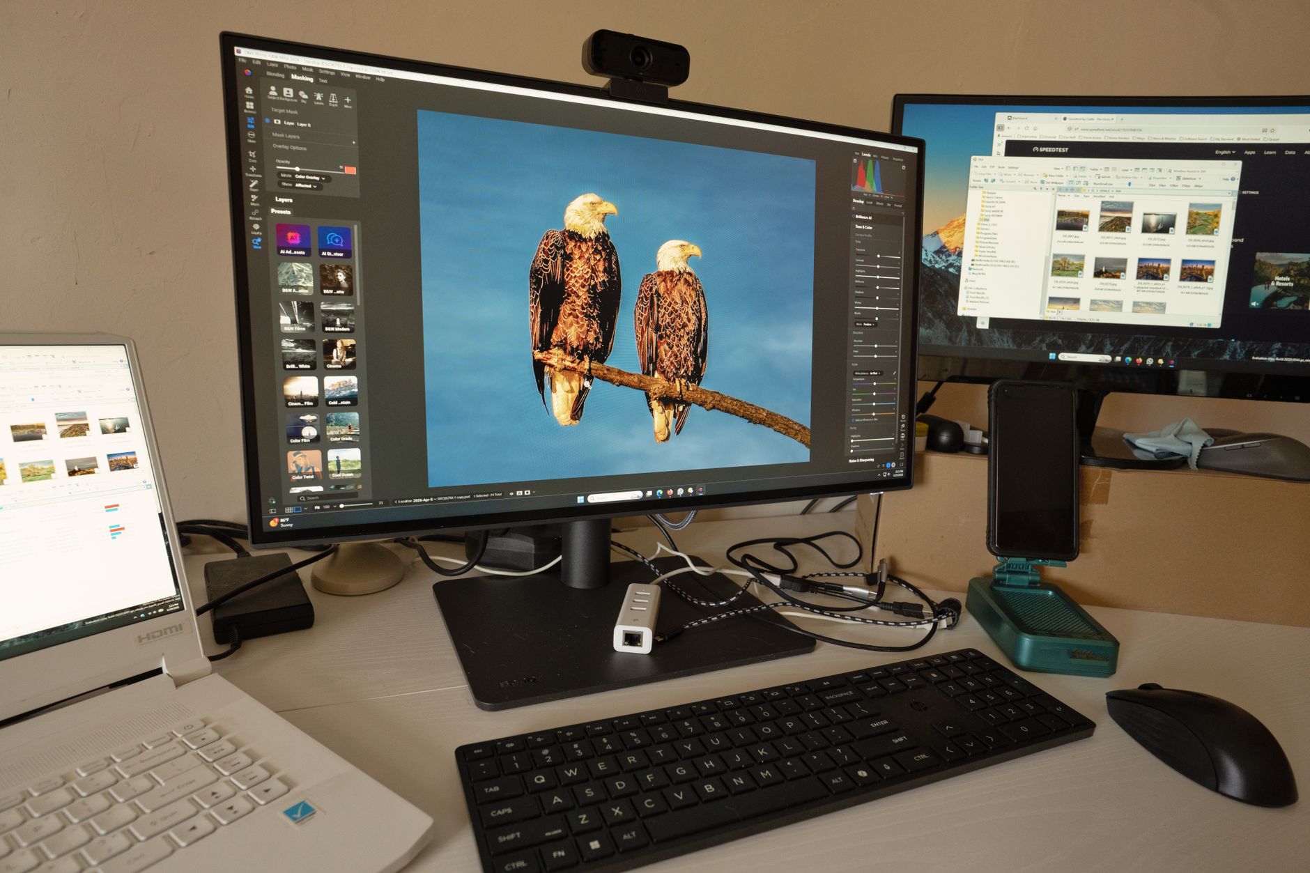 A business professional reviewing software tools and analytics on dual monitors at a desk