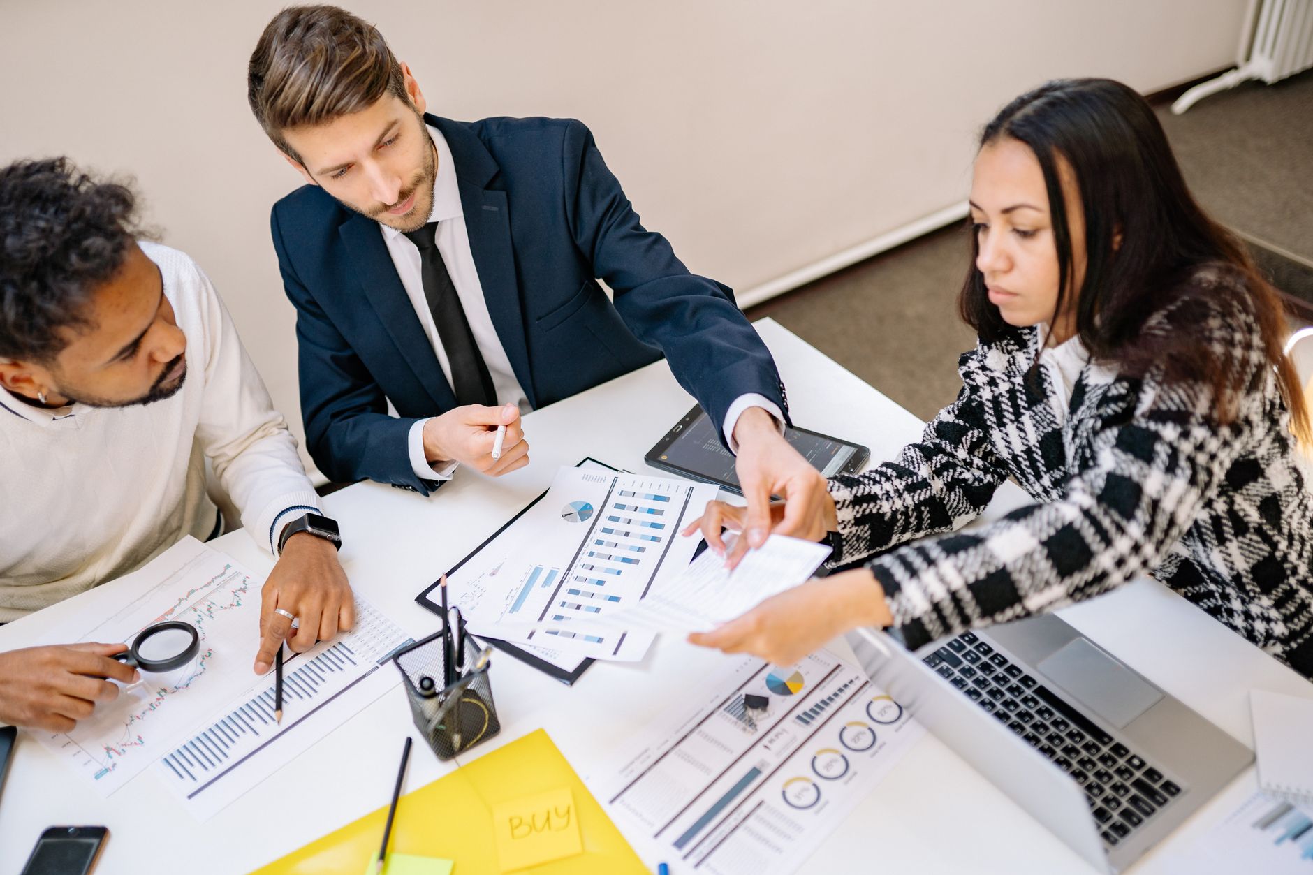 Marketing team discussing digital strategy and tool consolidation around a conference table