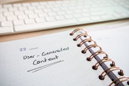 A workspace with a content calendar and laptop used for social media planning