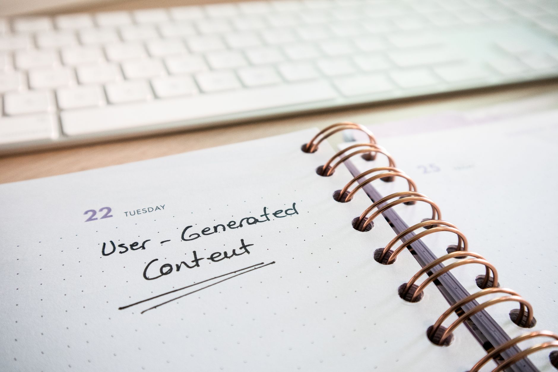 A workspace with a content calendar and laptop used for social media planning