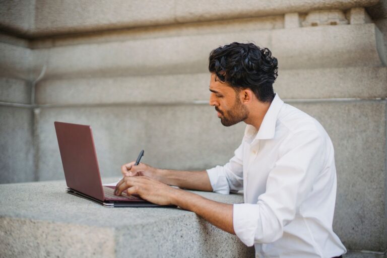 A content creator working on a laptop, building a subscription platform