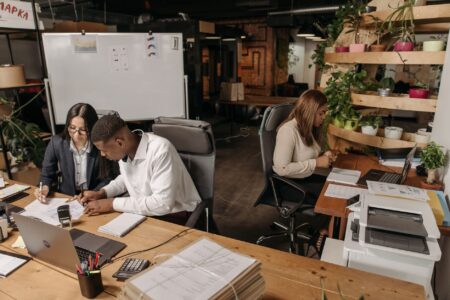 Social media agency team working at desks with multiple screens