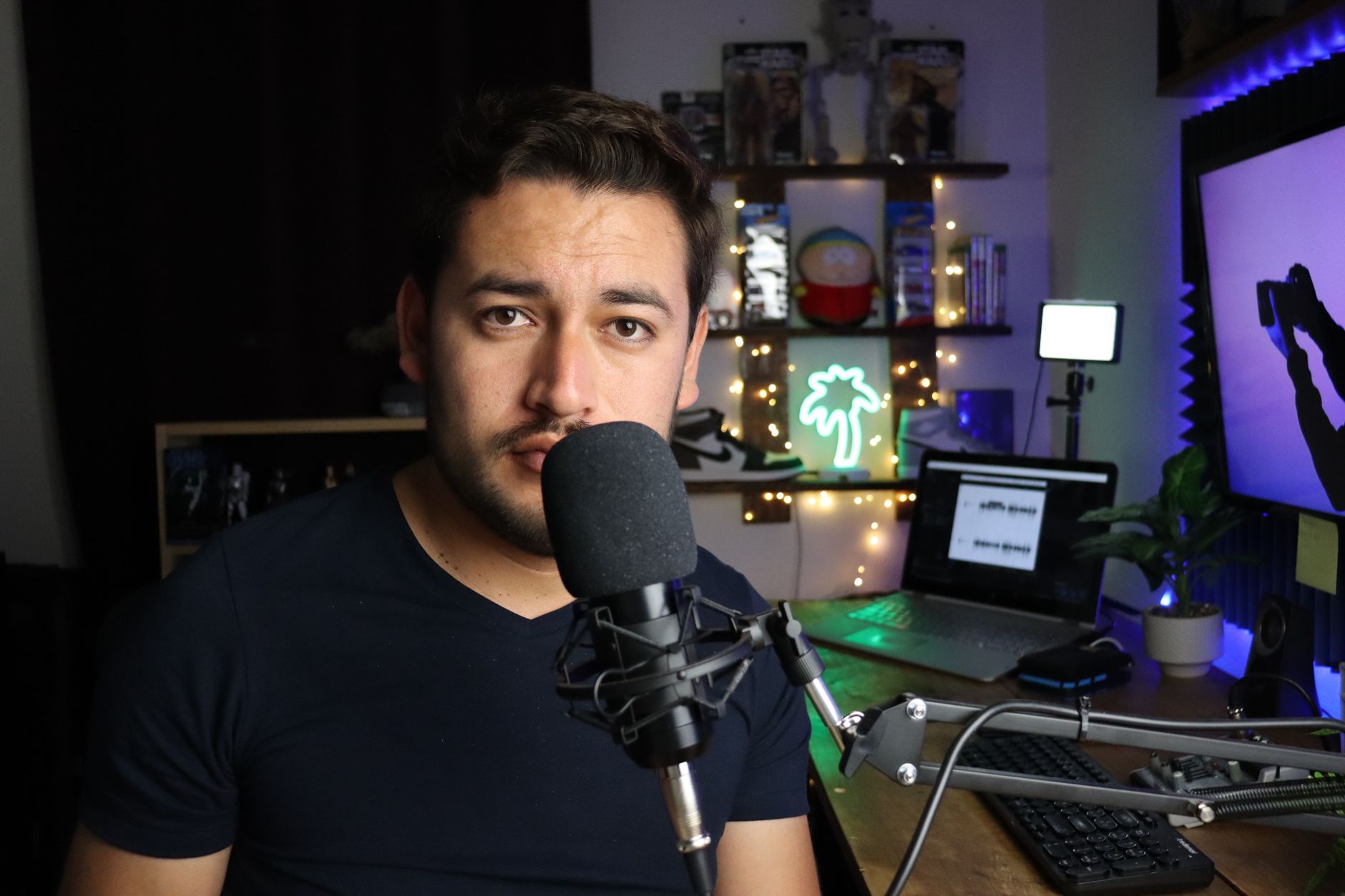 Solo content creator working at a minimalist home desk with laptop and notebook