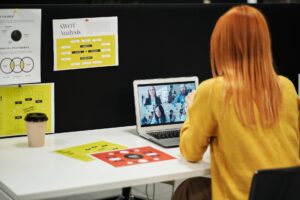 Remote team collaborating asynchronously on laptops during a virtual meeting