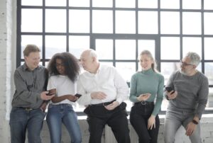 A social media marketing team reviewing content on laptops in a modern office