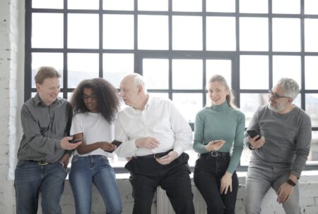 A social media marketing team reviewing content on laptops in a modern office