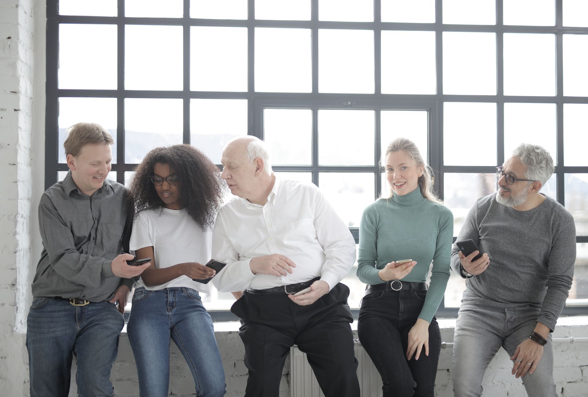 A social media marketing team reviewing content on laptops in a modern office