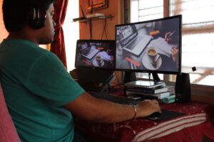 Freelancer working at a desk with multiple screens showing analytics dashboards
