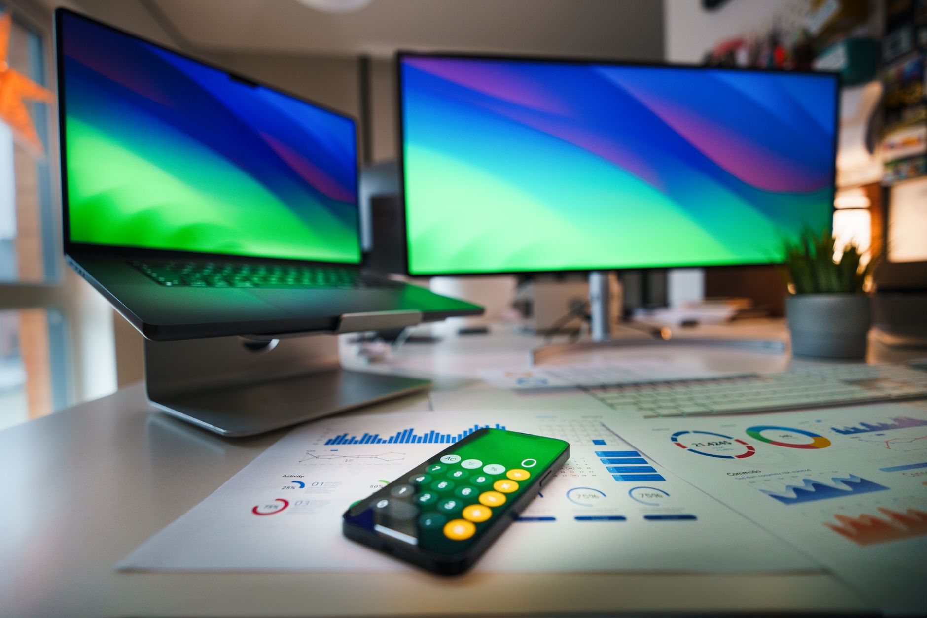 A modern desk setup with a laptop open to a digital workspace tool used for project management and forms