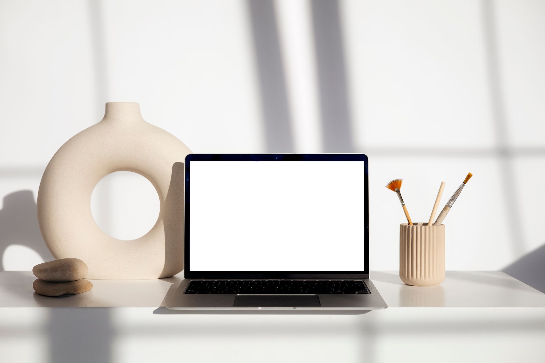 A creative professional working on brand design at a laptop in a modern workspace