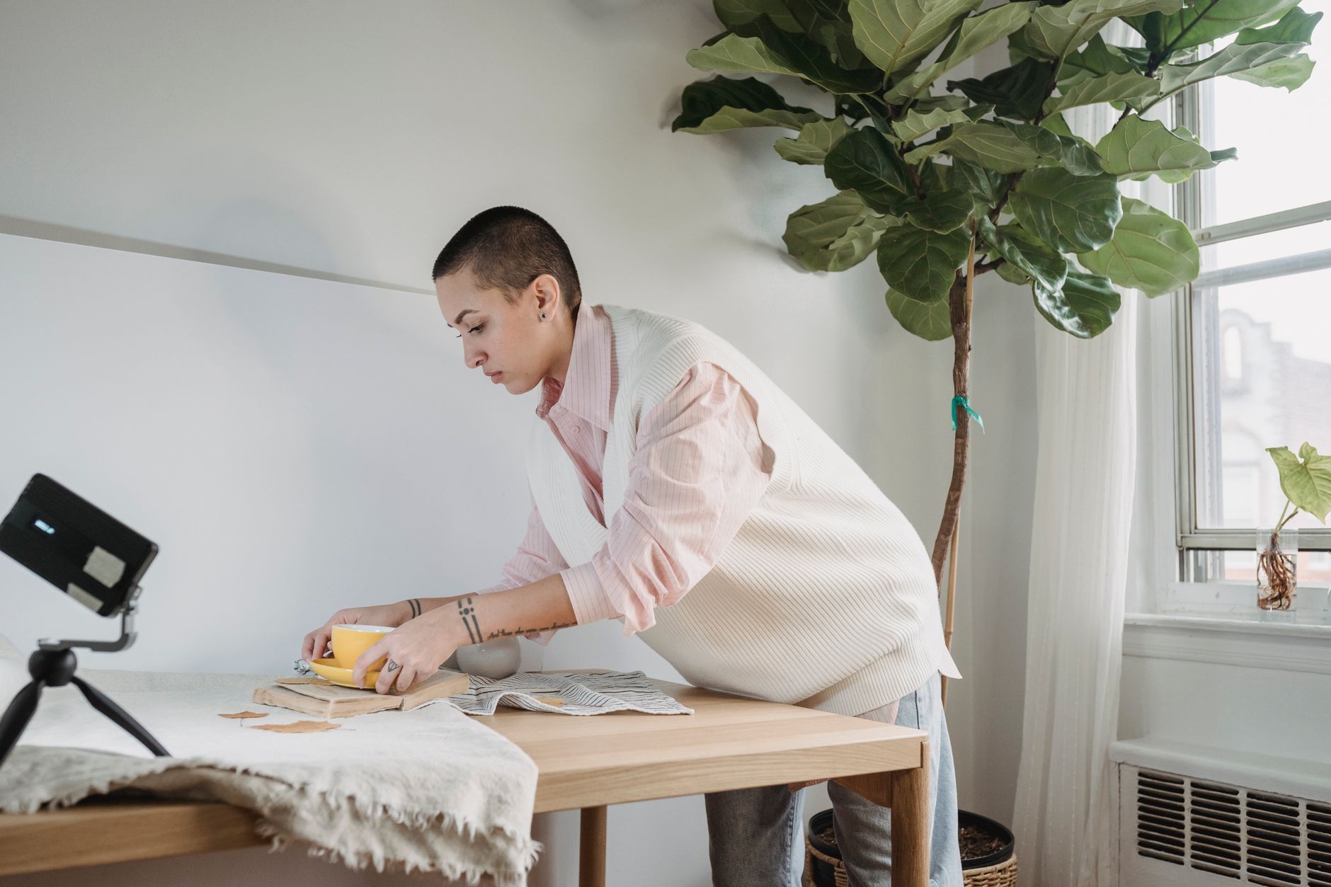A person working on a laptop at a desk, focused on content creation tasks