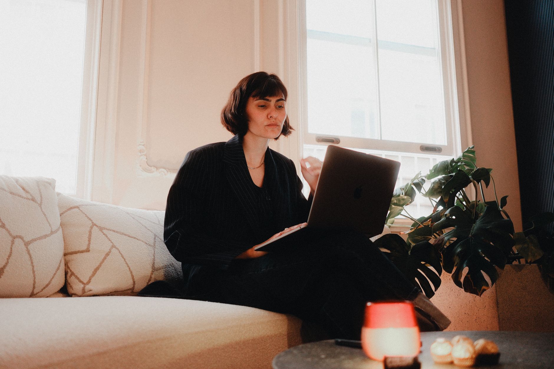 A woman working on a laptop managing social media content