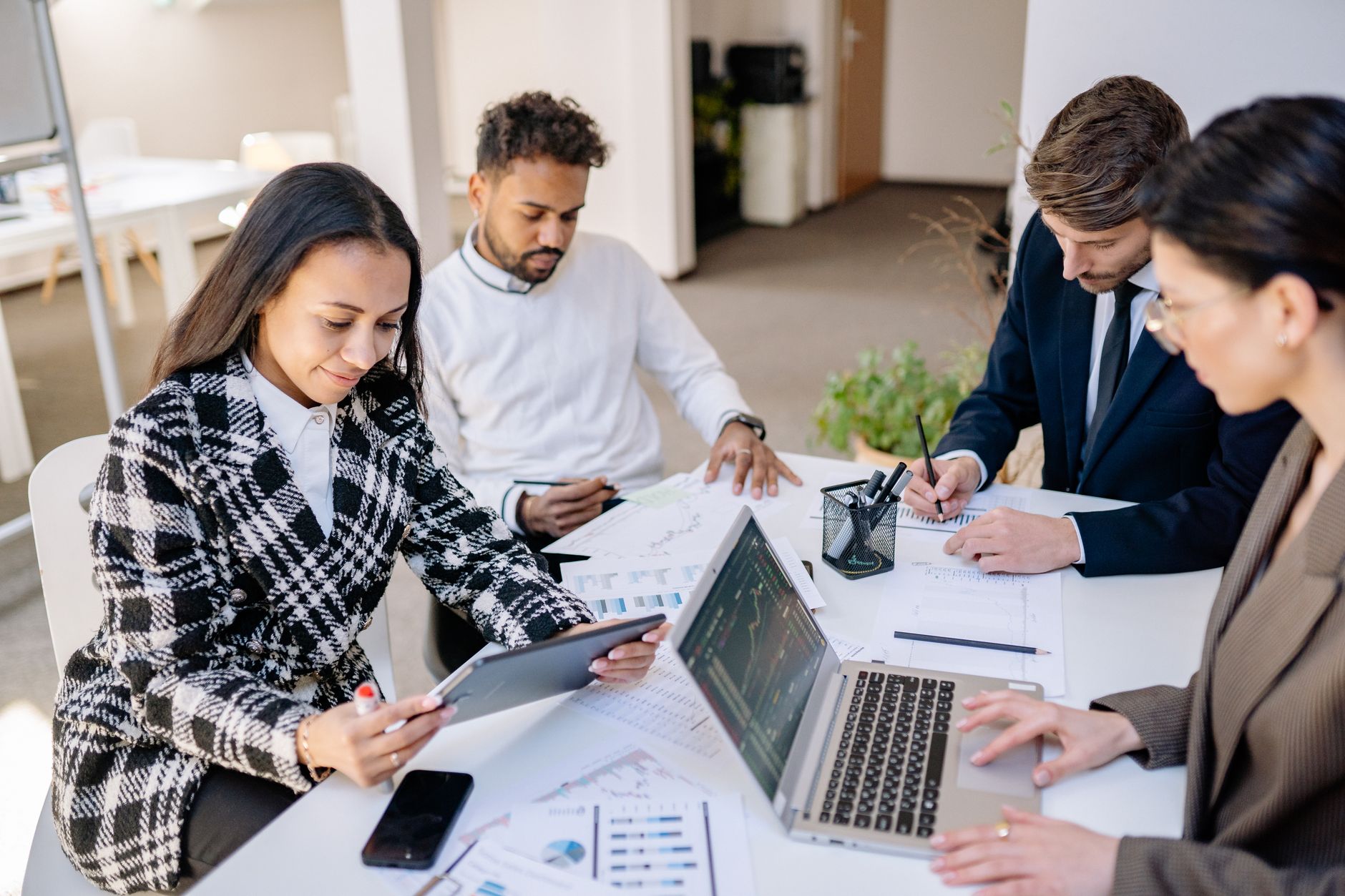 A small marketing team reviewing campaign performance on laptops