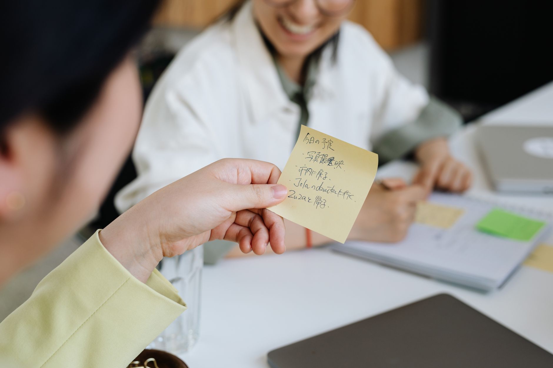 Small team reviewing documentation and notes together in a modern office setting