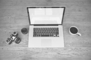 Creator working on a newsletter at a laptop in a minimal workspace