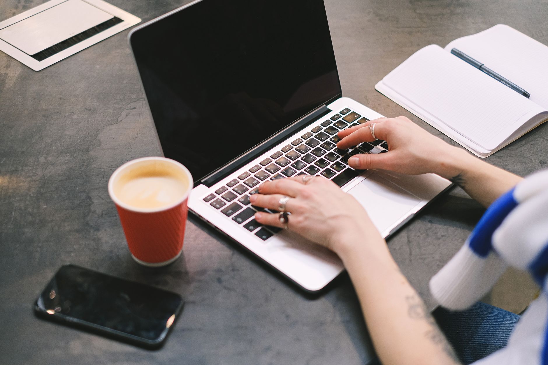 Freelancer working at a desk with laptop managing social media accounts