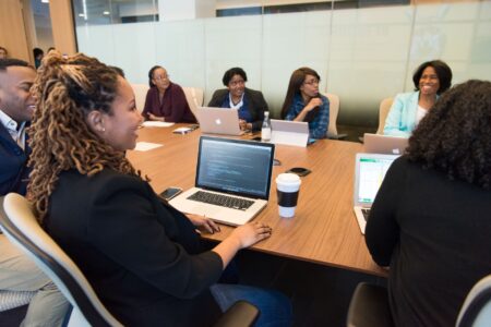 A woman coach working on her laptop managing social media content scheduling