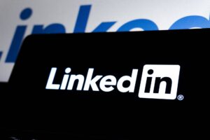 Person browsing LinkedIn profiles on a laptop screen for prospecting