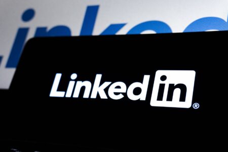 Person browsing LinkedIn profiles on a laptop screen for prospecting