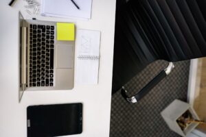 Professional working on LinkedIn outreach strategy on a laptop at a clean desk