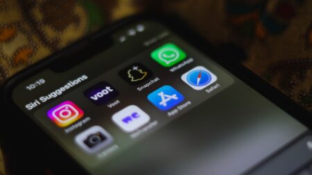 Person scrolling through a messaging app on a smartphone, representing WhatsApp business automation