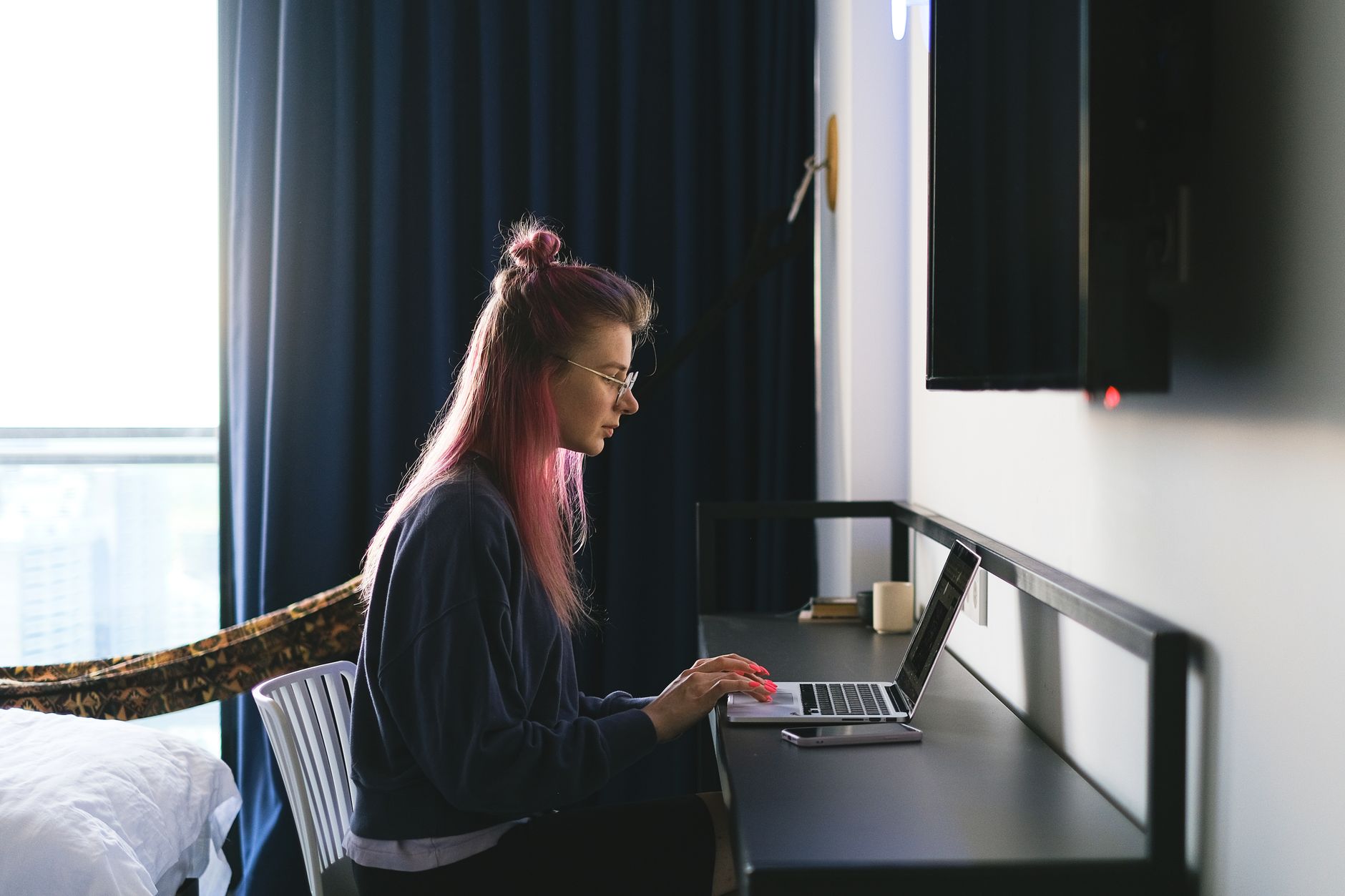 Freelancer working on a laptop at a desk managing social media accounts