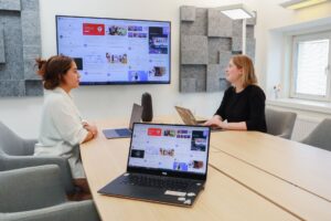Notion’s Social Media Calendar Is Quietly Replacing Trello for Content Teams Content team collaborating around laptops in a modern office workspace