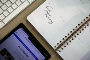 A marketing professional reviewing a social media content calendar on a laptop