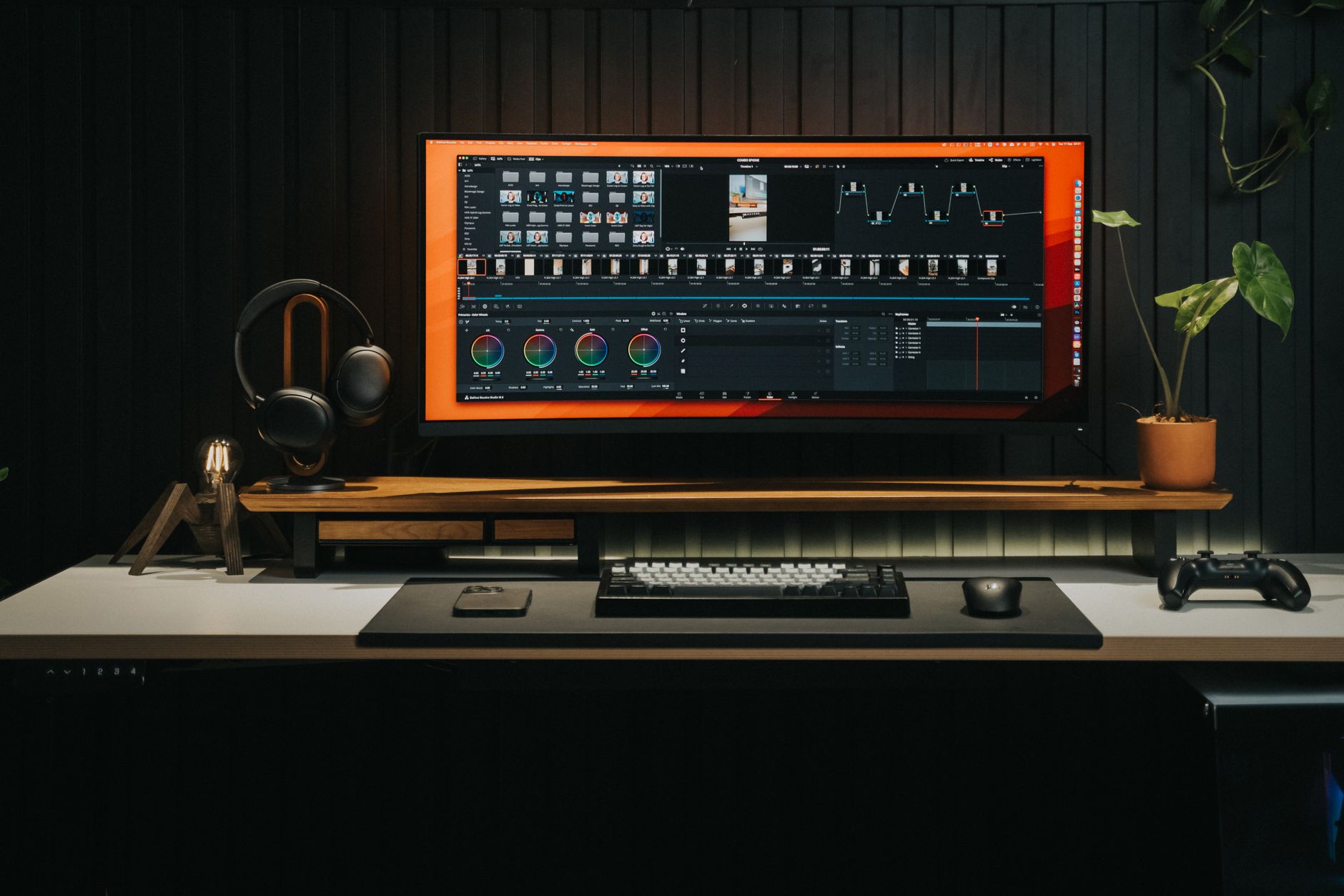 A content creator editing video on a desktop computer with multiple monitors showing timeline and footage