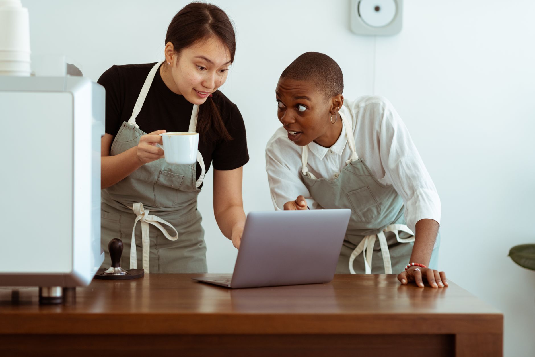 A small marketing team reviewing content strategy on a laptop in a modern office