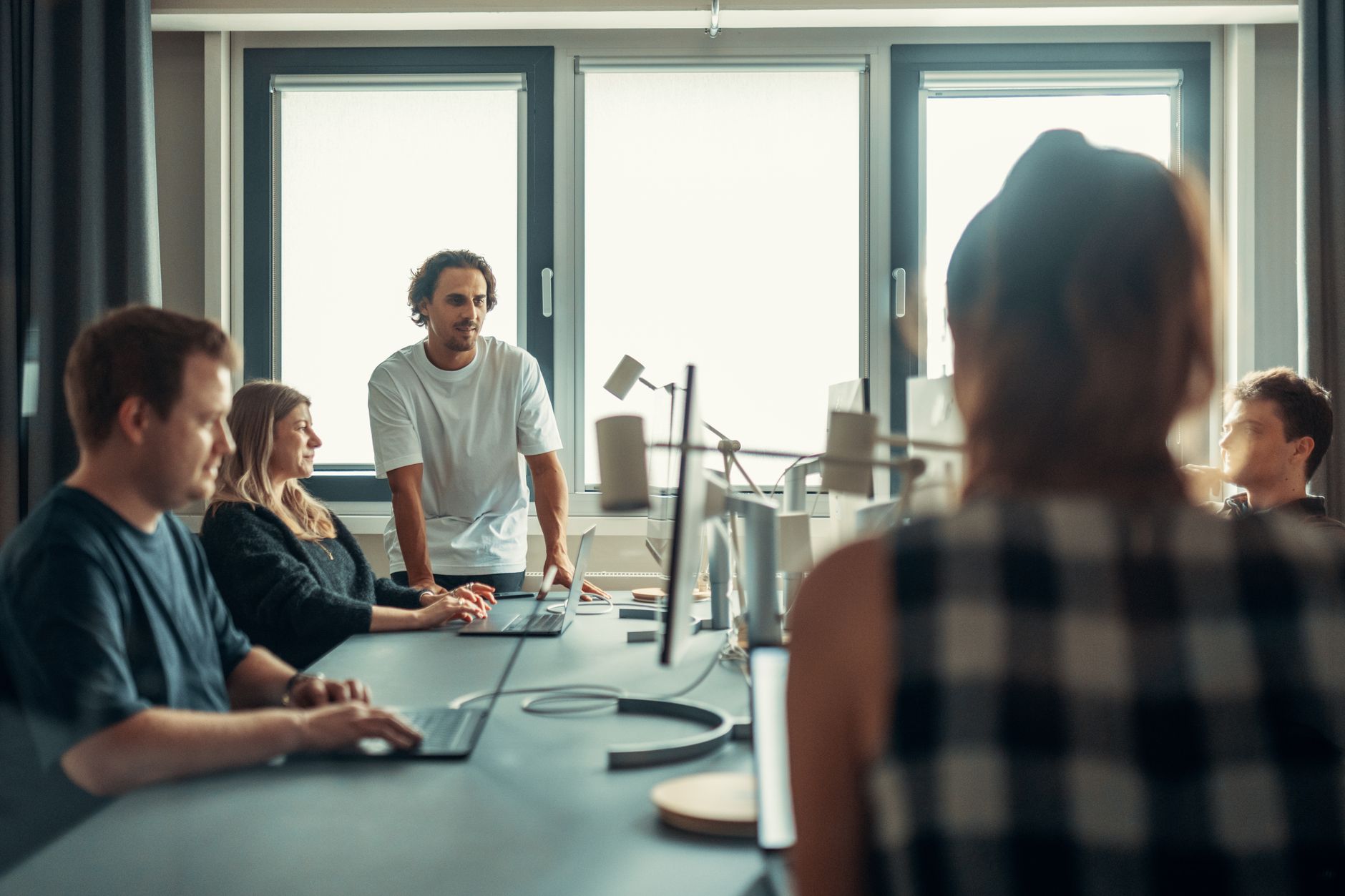 A small team reviewing documents and screens in a content planning session