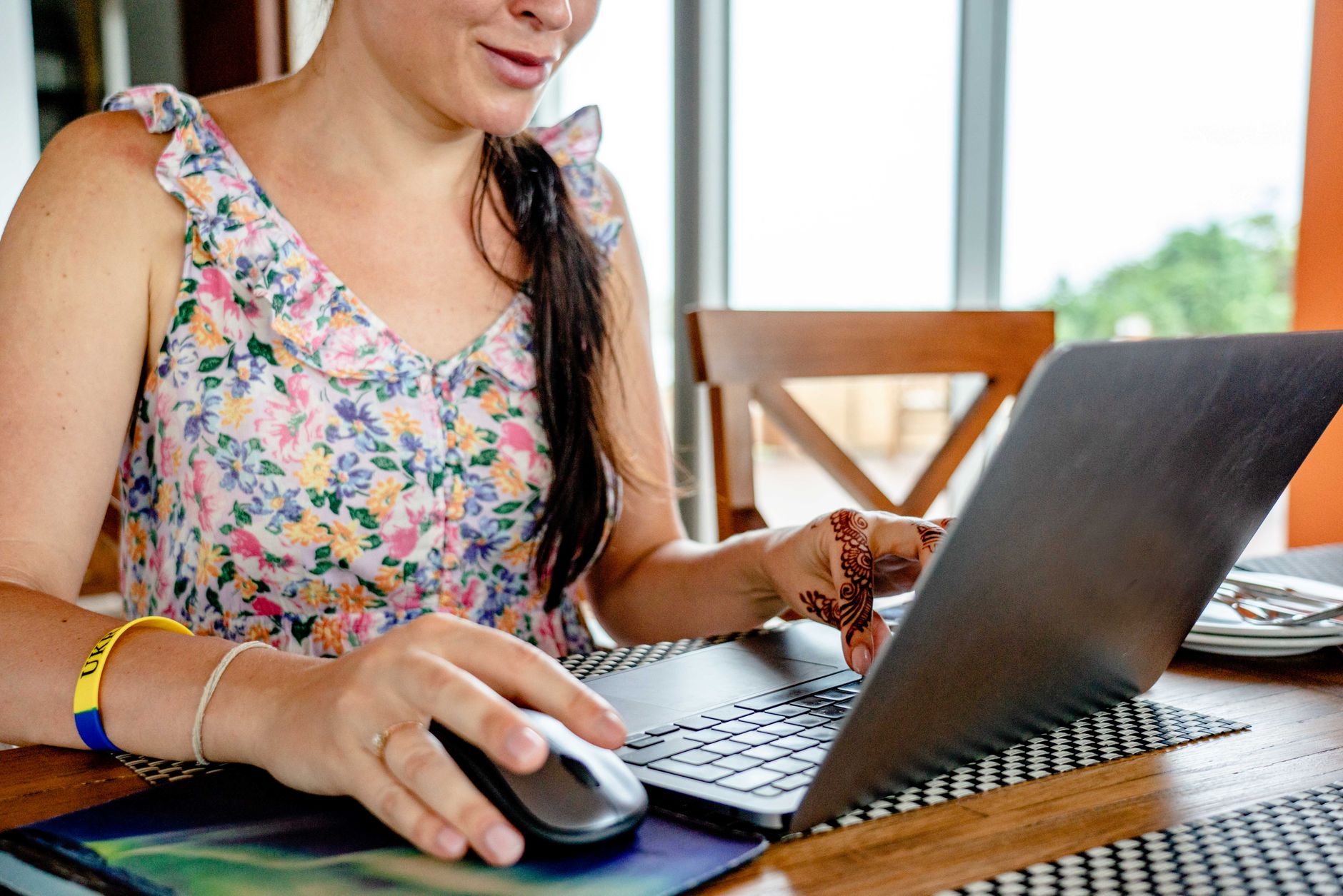 A social media manager working on a laptop reviewing brand monitoring alerts