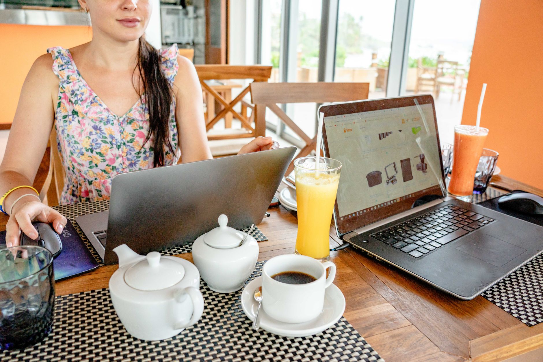 A woman reviewing content on a laptop, representing a solo creator or social media manager